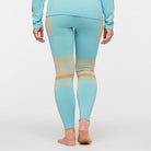 Women's Cotopaxi Debajo Seamless Baselayer Tights. Blue, tan, and orange pattern. Back view.