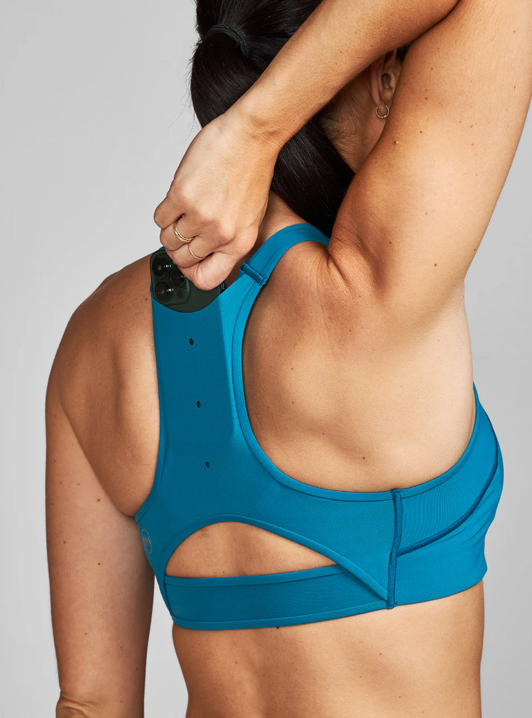 Women's Janji Ascend Sports Bra. Blue colorway. Back view.