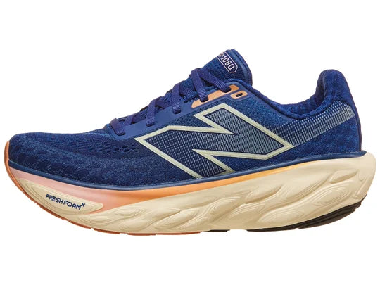 Women's New Balance 1080 v14. Blue upper. Off white, orange, and pink midsole. Lateral view.