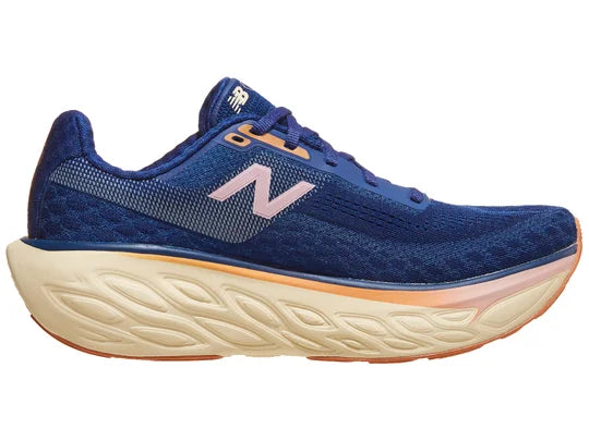 Women's New Balance 1080 v14. Blue upper. Off white, orange, and pink midsole. Medial view.