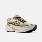 Women's New Balance Ellipse. Black, gold, and white upper. White and gold midsole. Lateral view.