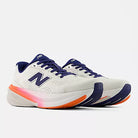 Women's New Balance 860 v15. White upper. White/Pink/Orange midsole. Lateral view.
