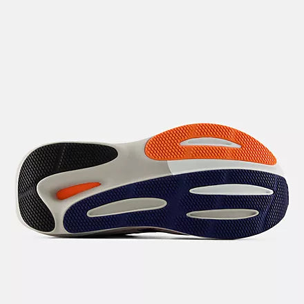 Women's New Balance 860 v15. White upper. White/Pink/Orange midsole. Bottom view.