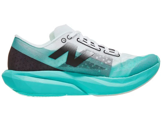 Women's New Balance Rebel v4. Green upper. Green midsole. Medial view.