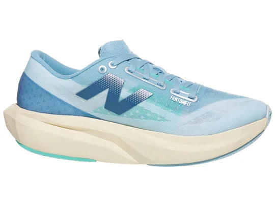 Women's New Balance Rebel v4. Blue upper. Off white midsole. Medial view.