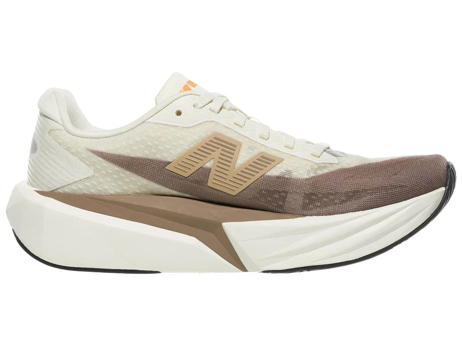 Women's New Balance Rebel v5. Off White/Tan upper. Off White/Tan midsole. Medial view.