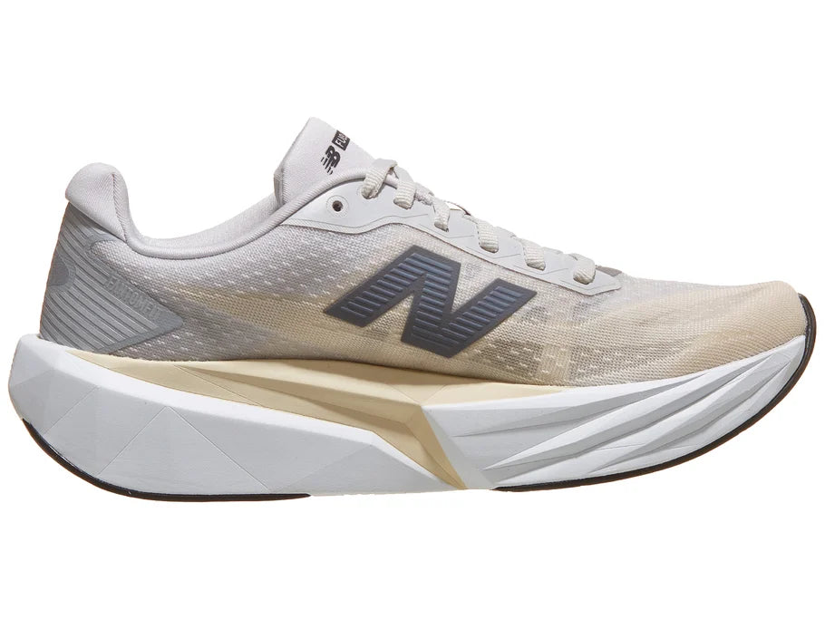 Women's New Balance Rebel v5. Grey upper. White midsole. Medial view.