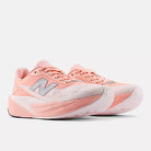 Women's New Balance FuelCell Rebel v5. White/Pink upper. White/Pink midsole. Lateral view.