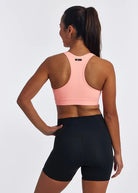Women's Oiselle Double Breasted Bra in Fast Pink, rear view.