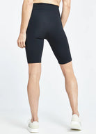 Women's Oiselle Essential Bird Long Shorts. Black. Rear view.