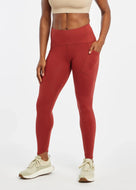 Women's Oiselle Flyout Tights in Redwood red, front view.
