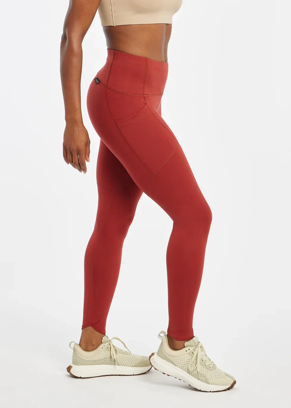 Women's Oiselle Flyout Tights in Redwood red, side view.