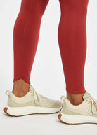 Women's Oiselle Flyout Tights in Redwood red, ankle detail.