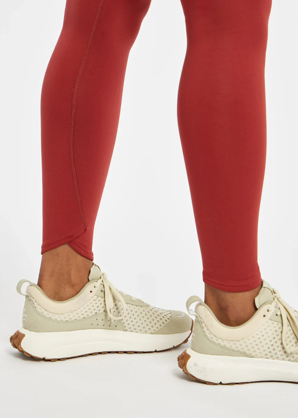 Women's Oiselle Flyout Tights in Redwood red, ankle detail.