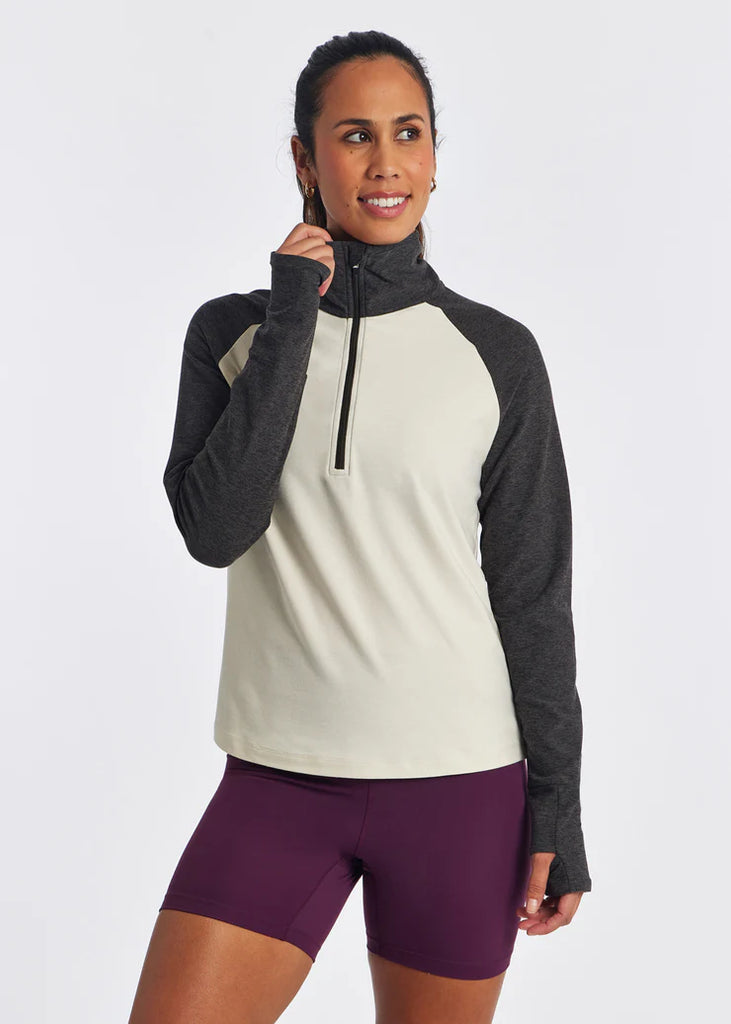 Women's On Running Lux Half Zip. Ivory torso. Dark sleeves. Front view.