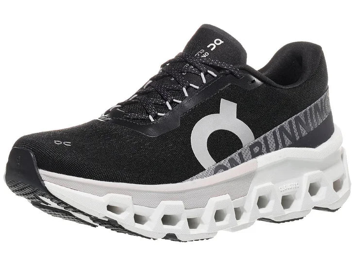 Women's On Cloudmonster 2. Black upper. White midsole. Lateral view.