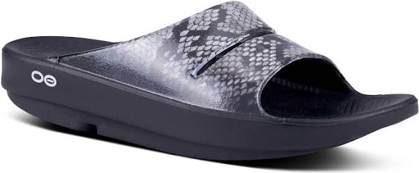 Women's Oofos OOahh Limited Slide. Grey and black snake pattern upper. Black midsole. Lateral view.