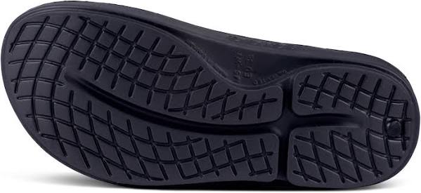 Women's Oofos OOahh Limited Slide. Grey and black snake pattern upper. Black midsole. Bottom view.