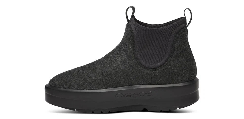 Women's Oofos Londoner Boot. Black upper. Black midsole. Medial view.