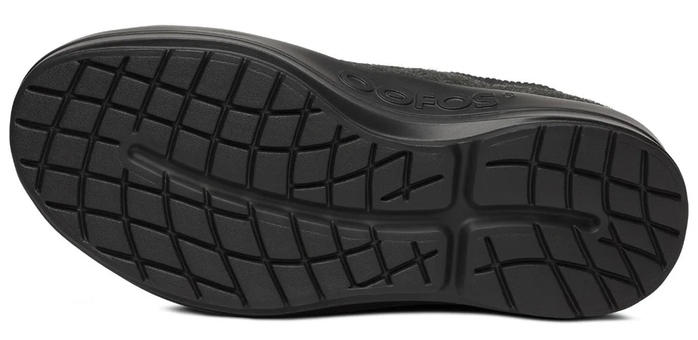 Women's Oofos Londoner Boot. Black upper. Black midsole. Bottom view.