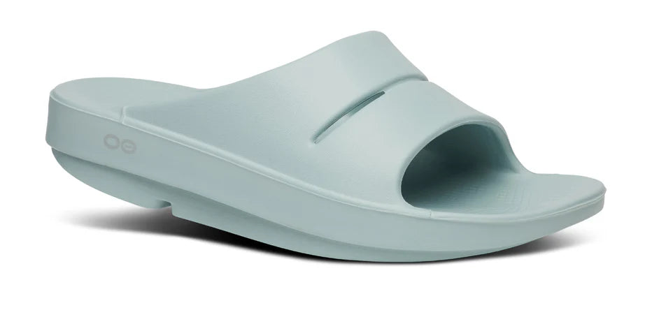 Oofos Ooahh Slide. Light Blue. Lateral view.