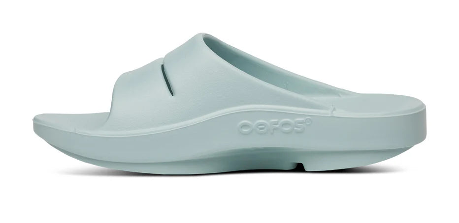 Oofos Ooahh Slide. Light Blue. Medial view.