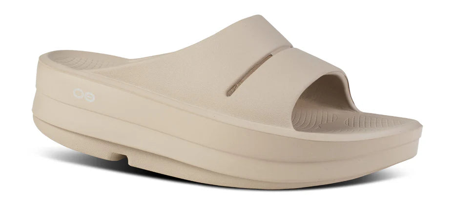 Women's Oofos Oomega Ooahh Slide. Tan. Lateral view.