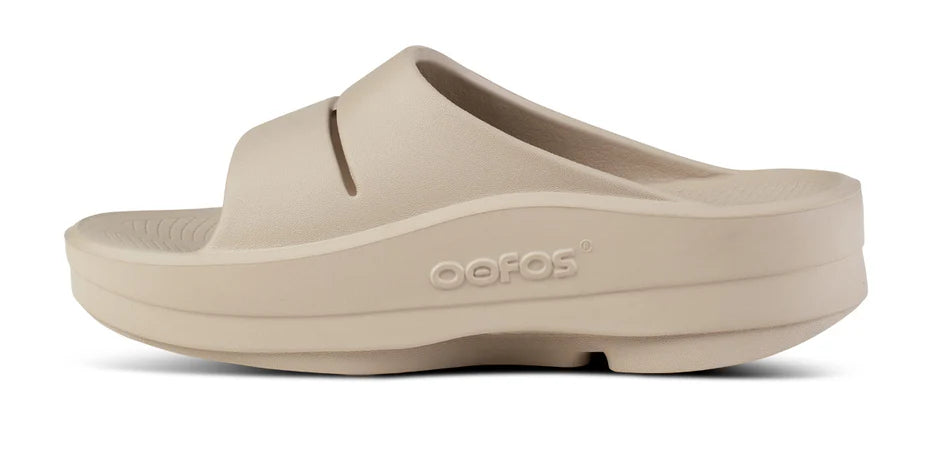 Women's Oofos Oomega Ooahh Slide. Tan. Medial view.