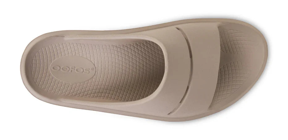 Women's OOFOS OOmega OOahh Slide in Nomad. Tan. Top view.