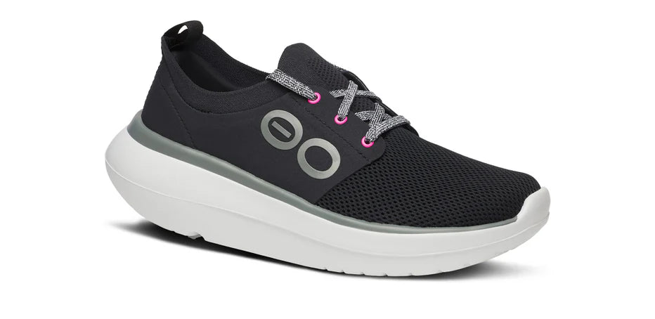 Women's Oofos OOmy Stride. Black upper. White midsole. Lateral view.