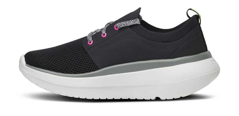 Women's Oofos OOmy Stride. Black upper. White midsole. Medial view.
