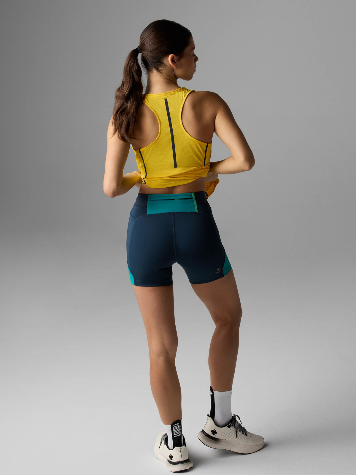 Women's Rabbit Pacer Shorts 4". Dark blue colorway. Back view.