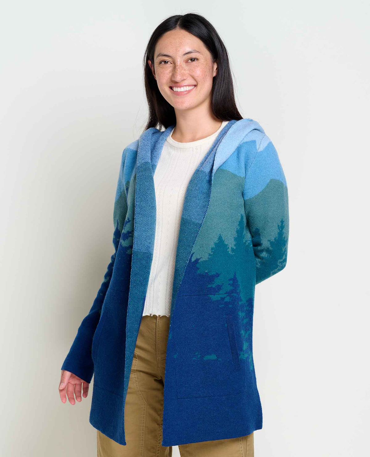 Women's Toad & Co Merino Wool Heartfelt Hoodie. Blue and green with sky and tree design.  Front view.