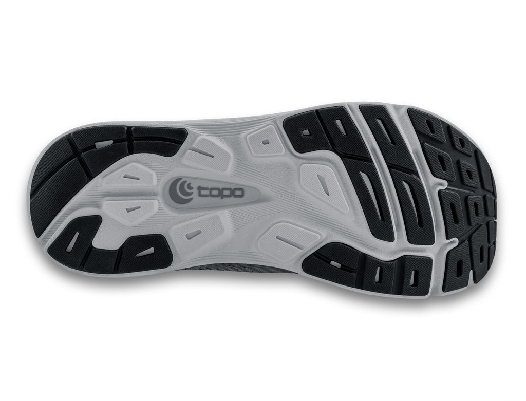 Women's Topo Magnifly 5. Black/Grey upper. Grey midsole. Bottom view.