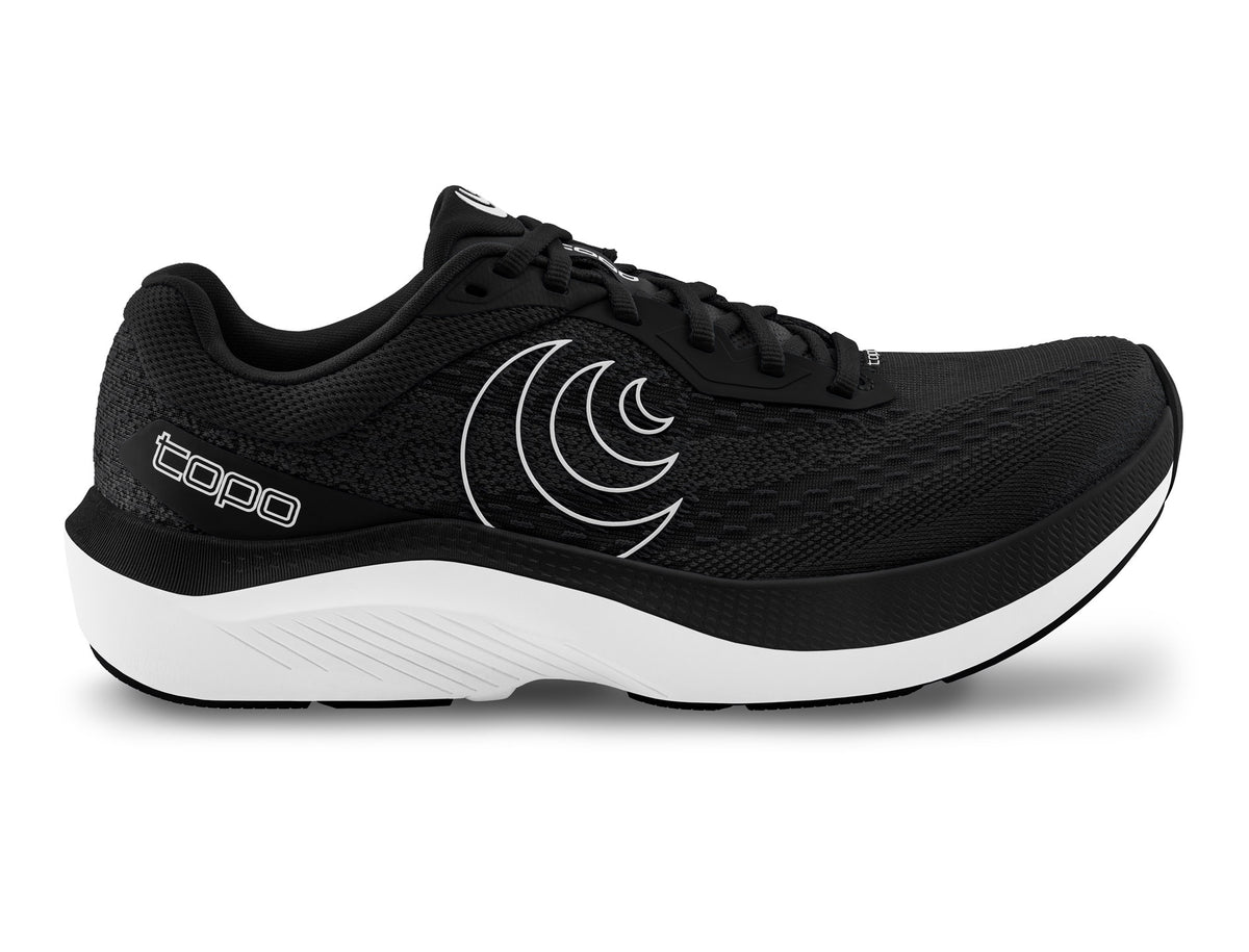 Women's Topo Magnifly 6. Black upper. White midsole. Lateral view.