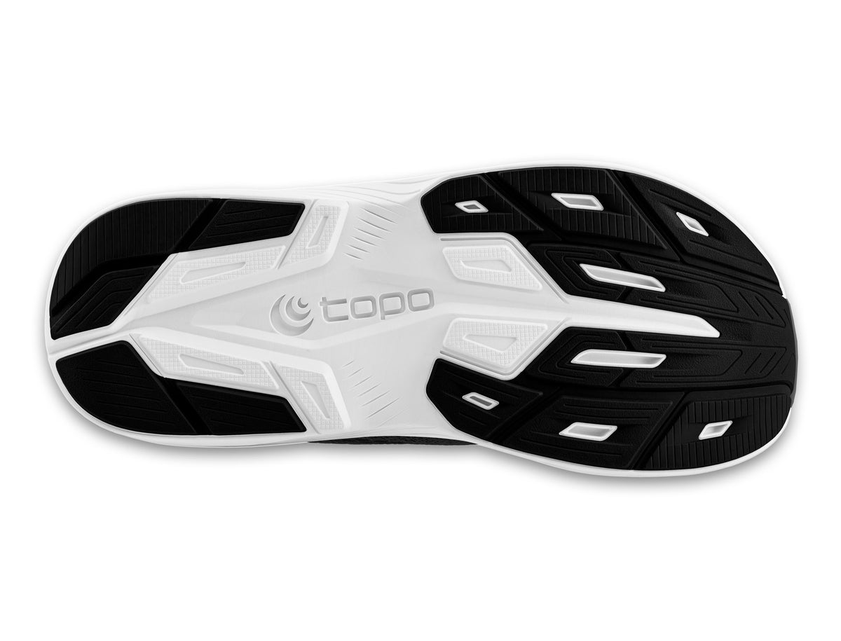 Women's Topo Magnifly 6. Black upper. White midsole. Bottom view.