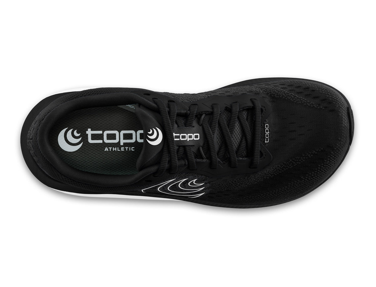 Women's Topo Magnifly 6. Black upper. White midsole. Top view.