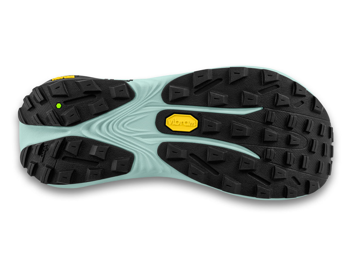 Women's Topo Vista. Black upper. Green midsole. Bottom view.