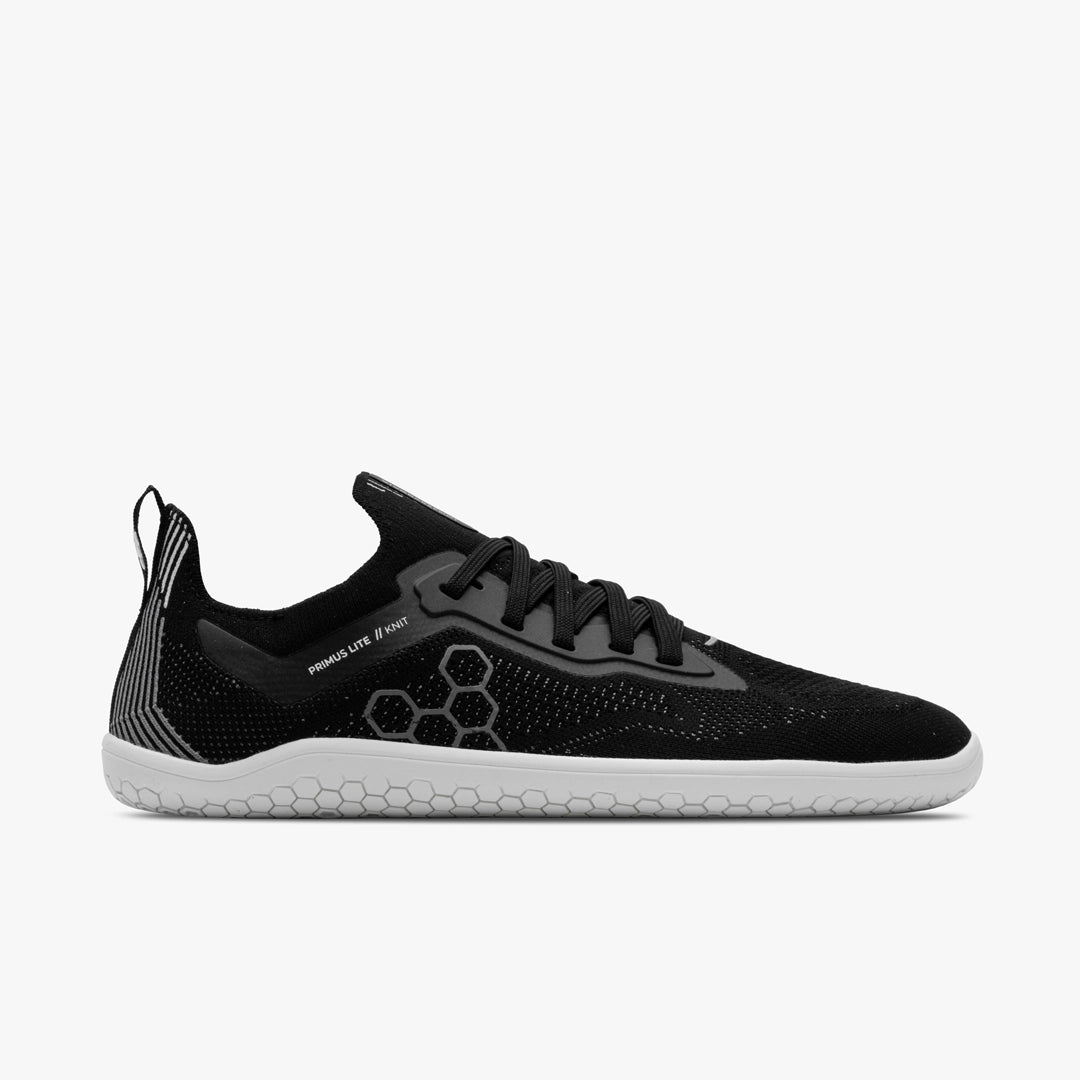 Women's Vivobarefoot Primus Lite Knit. Black upper. White outsole. Lateral view.