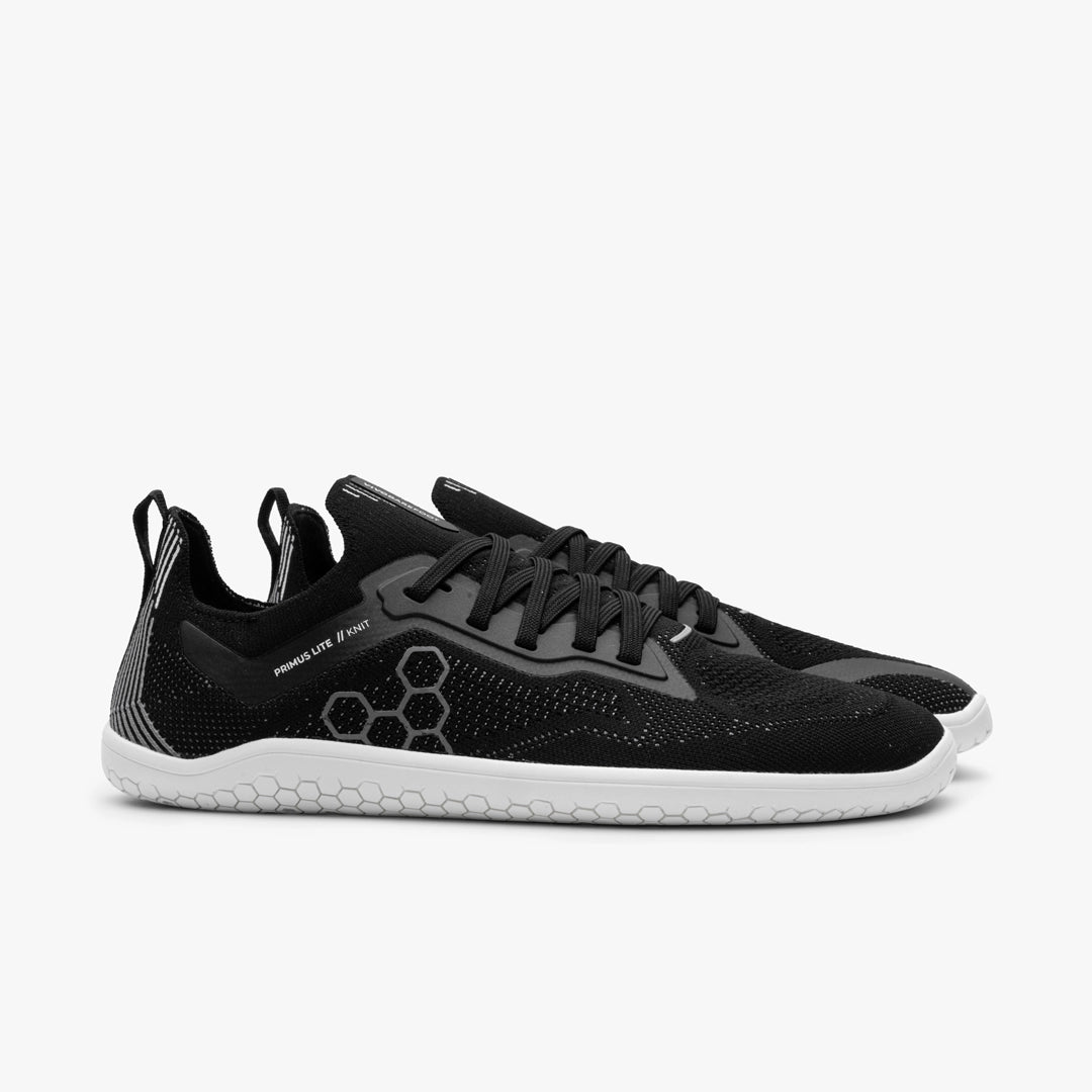 Women's Vivobarefoot Primus Lite Knit. Black upper. White outsole. Lateral view.