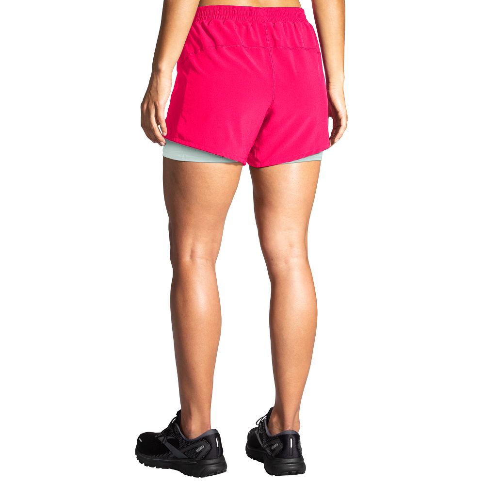 Women's Brooks Moment 5" 2-in-1 Shorts. Pink. Rear view.