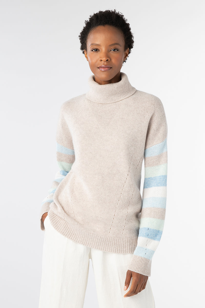Kinross women's cashmere turtleneck in Agate Multi worn from the front, showing pale striped sleeves and a neutral body