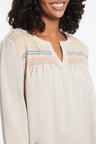 Tribal women's Smocked Henley Top in Oatmeal, close-up of the neckline and colorful front smocking.
