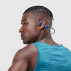 Shokz OpenRun Headphones Blue shown on male model.