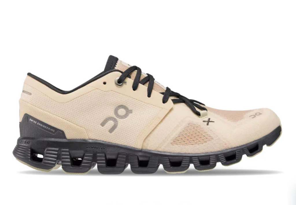 Women's On Cloud X3. Tan upper. Black midsole. Lateral view.