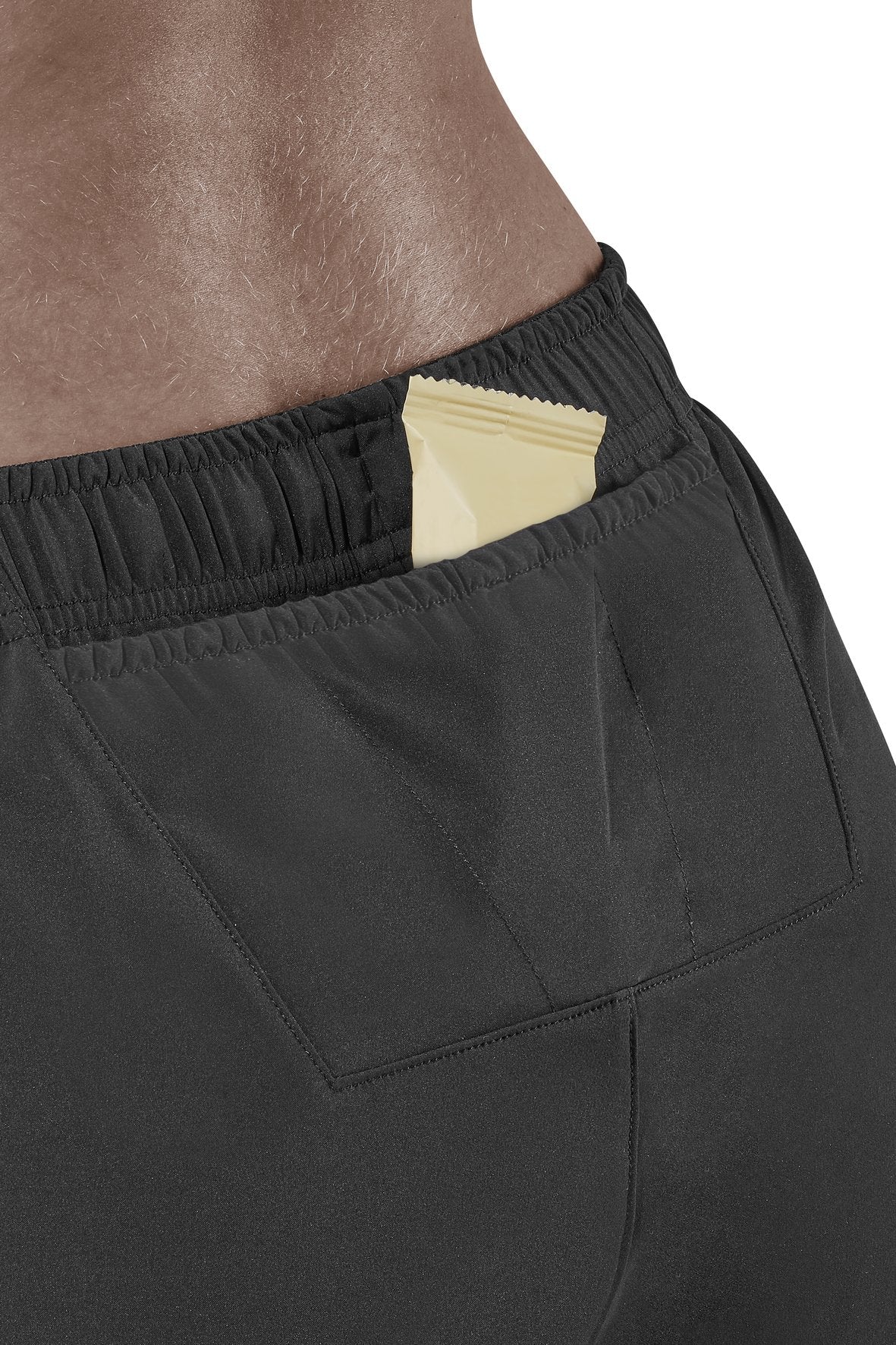 Women's CEP Race Loose Fit Shorts. Black. Rear pocket view.