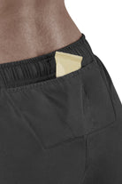 Women's CEP Race Loose Fit Shorts. Black. Rear pocket view.