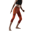 Women's CEP Ski Tights. Dark Orange. Front/Lateral view.