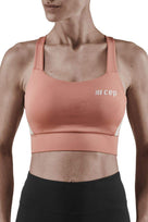 Women's CEP Sports Bra. Rose. Front view.